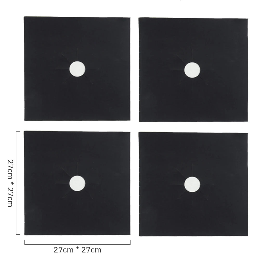 A set of four black square protectors, each featuring a white circular cutout for a gas stove.