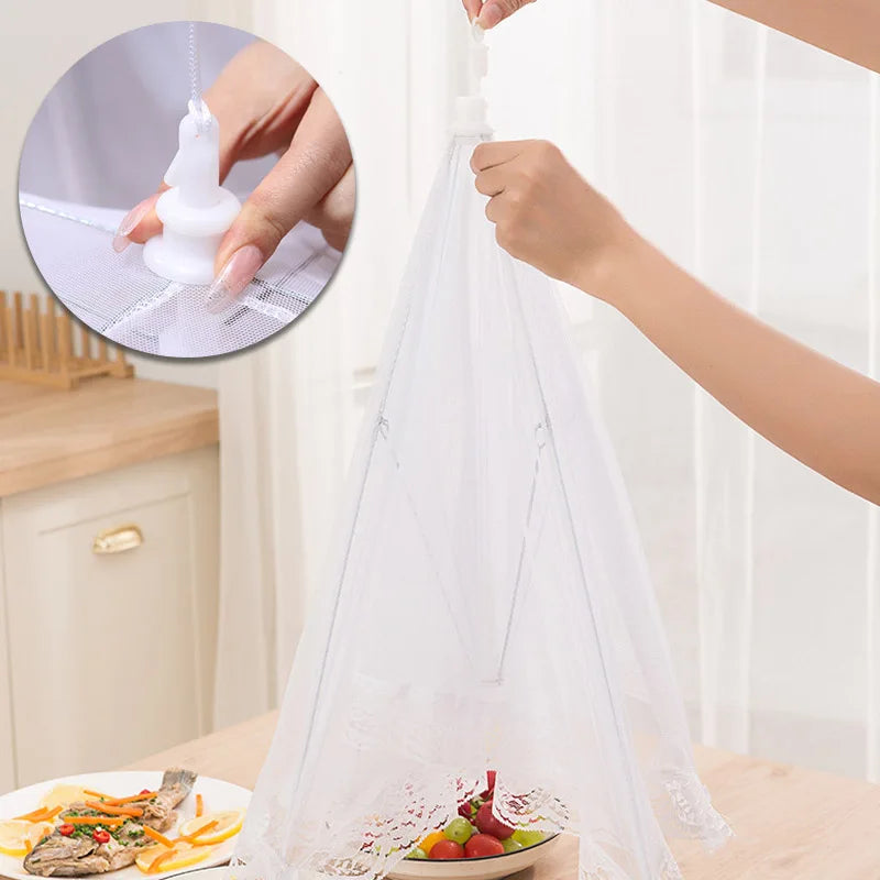A white foldable mesh insect and fly protection cover is being used to cover food items.