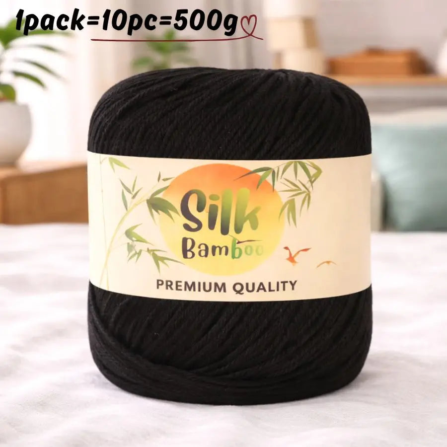 Black silk bamboo blend yarn skein with a label indicating premium quality