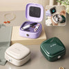 A purple magnetic sewing kit with specialty needles and thread is displayed on a light wooden surface.