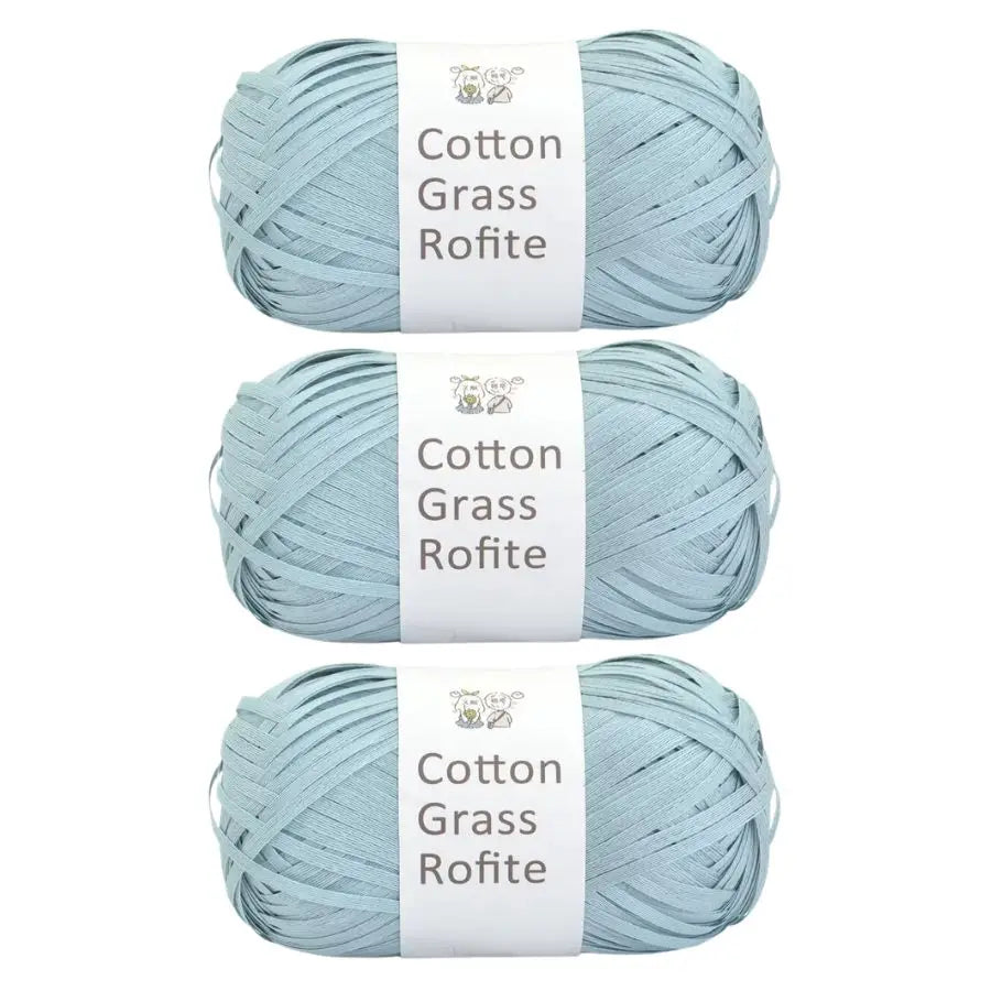 A ball of light blue cotton grass roving yarn labeled Cotton Grass Rofite