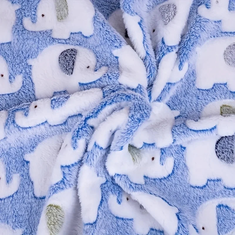 A soft blue and white flannel blanket patterned with cute elephants, folded in a cozy texture.