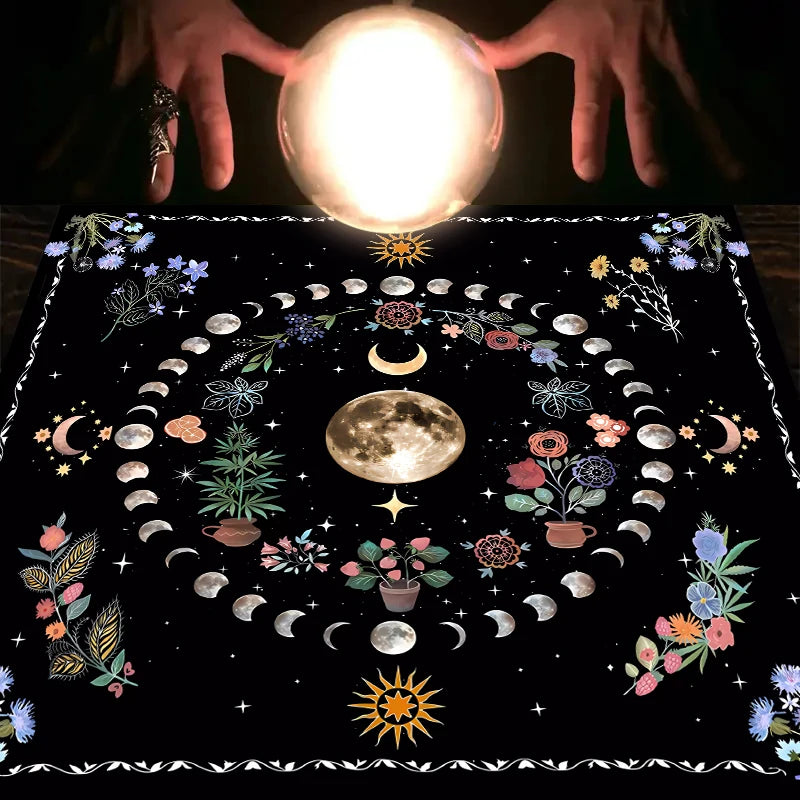 A dark mat featuring a full moon, crescent moons, floral elements, and a sun design for tarot readings.
