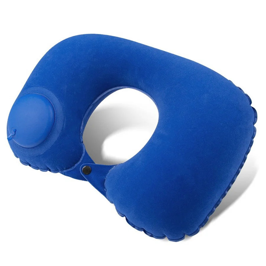 A bright blue inflatable neck pillow with a rounded shape and a small circular feature.