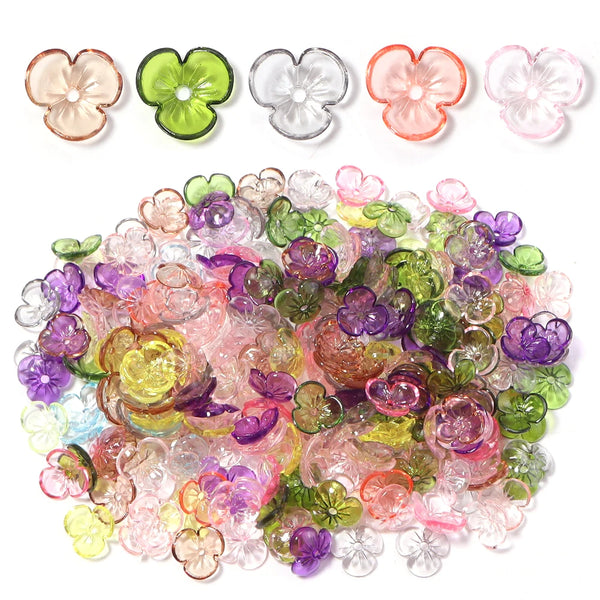 A collection of resin flower bead caps in various shades of pink, green, purple, and clear for jewelry making.