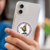A hand holds a white smartphone displaying a funny meme decal that reads Don't blame me I vote pizza party