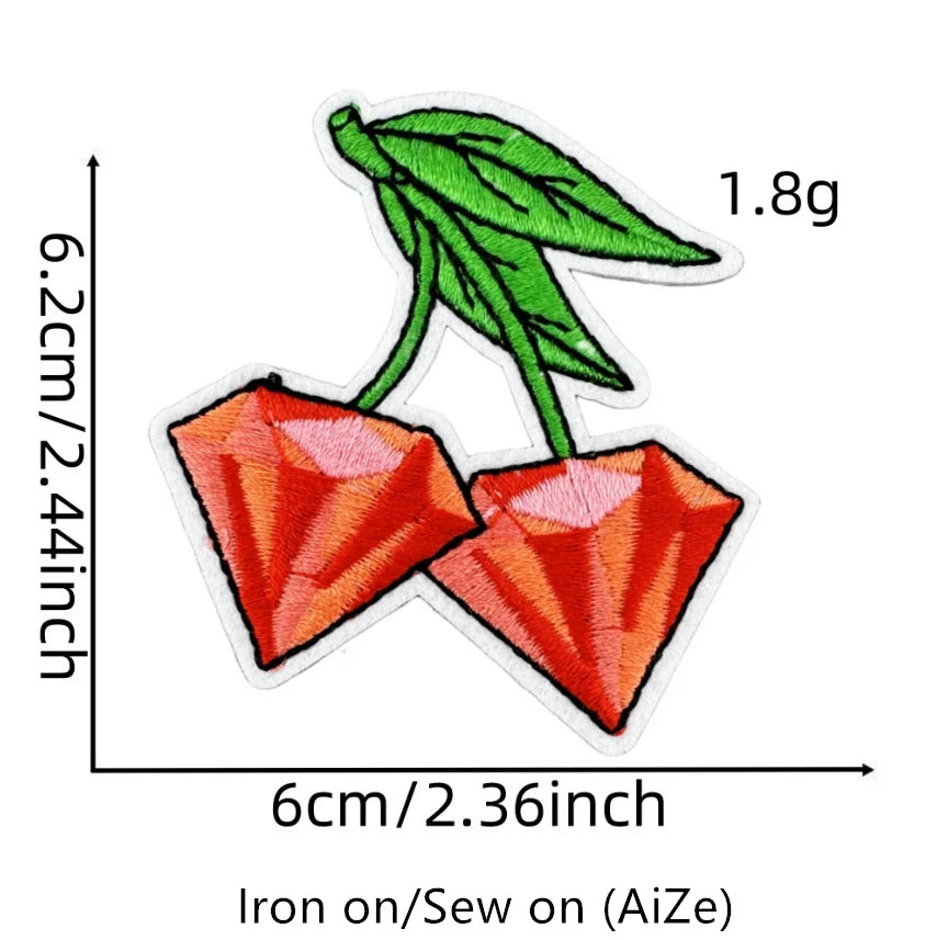 A green leaf attached to a red, diamond-shaped fruit patch for iron-on crafting.