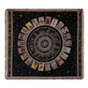 A dark geometric throw blanket featuring a central sunburst design with radiating panels and fringed edges.