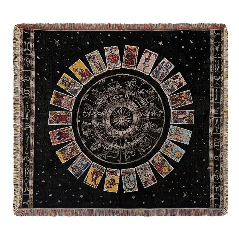 A dark geometric throw blanket featuring a central sunburst design with radiating panels and fringed edges.