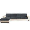 A modern, sectional sofa upholstered in dark gray fabric with cream-colored trim and seat cushions.