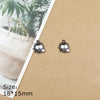 A pair of black ladybug resin charms on a brown cardstock background.