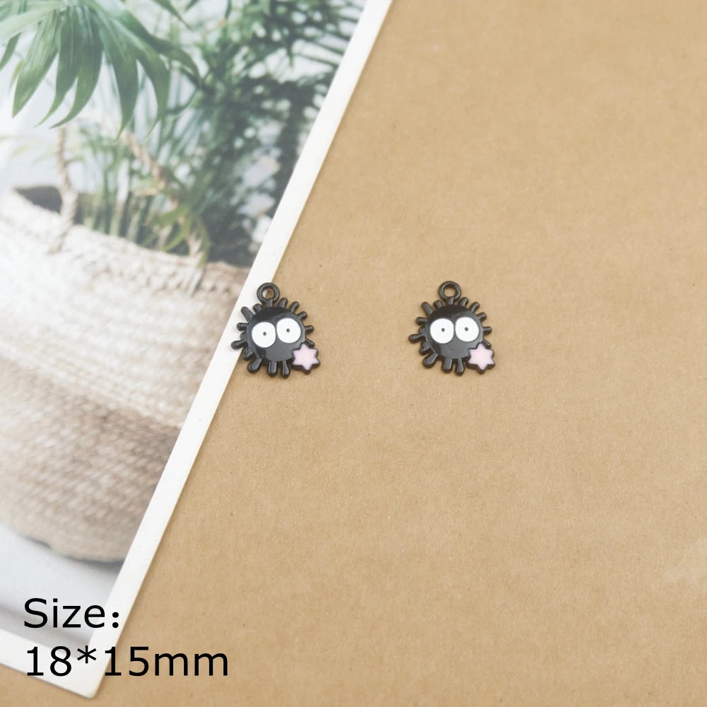 A pair of black ladybug resin charms on a brown cardstock background.