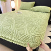 A light green plush jacquard mattress cover is shown on a bed, featuring an embossed diamond pattern.