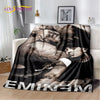 A dark graphic throw blanket featuring a vintage-inspired portrait of a woman and a man.