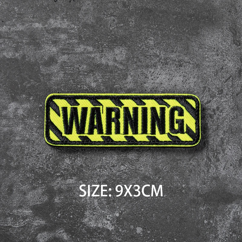 Yellow warning tape with black stripes, measuring 9x3cm.