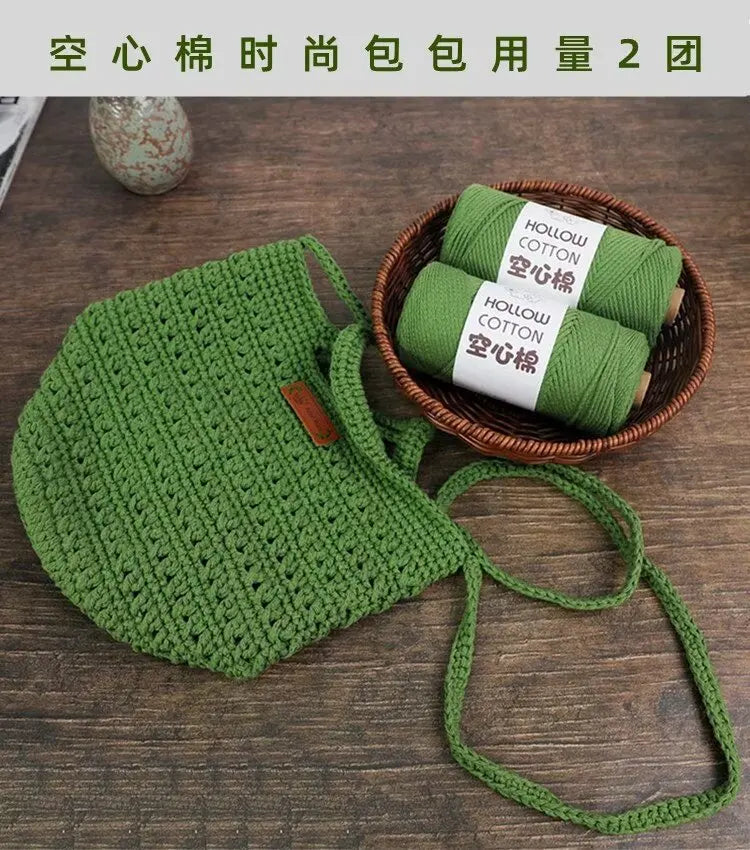 A hand-knitted green mesh face mask is shown next to two rolls of green hollow cotton yarn.