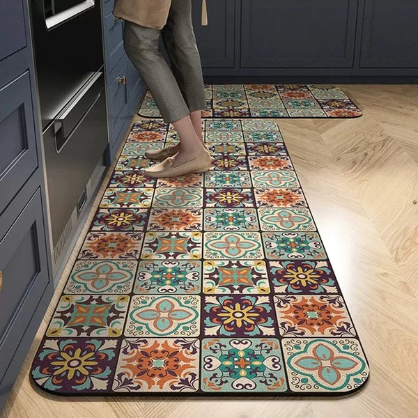 A long rectangular mat with a multicolored floral pattern is placed on a light wood floor next to dark cabinetry.