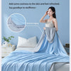 A light blue summer wave grid quilt is displayed on a bed, emphasizing natural coolness and a delicate edge.