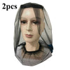 Two sheer black mosquito nets with face masks displayed on a mannequin head.