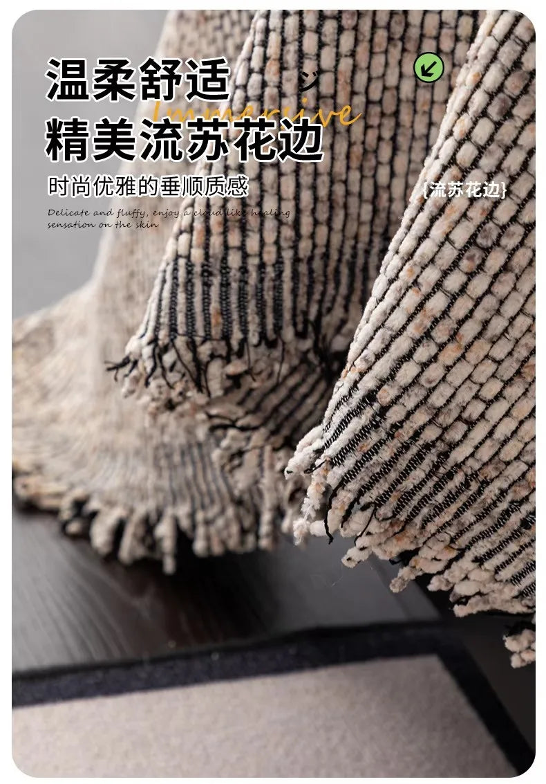 Close-up of a textured, knitted sofa cover in beige and black tones.