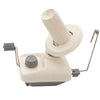A hand operated wool yarn winder with a white and gray plastic body and a cylindrical winding mechanism.