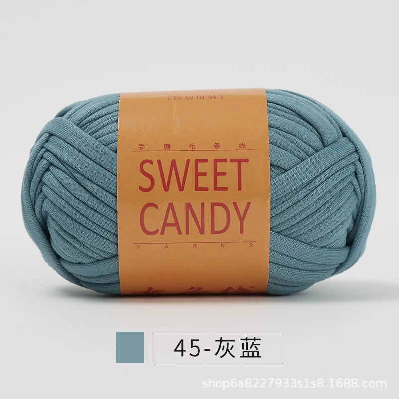 A ball of teal yarn labeled SWEET CANDY with Chinese characters on the label.