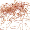 A pile of copper-colored safety bulb pins for knitting and sewing