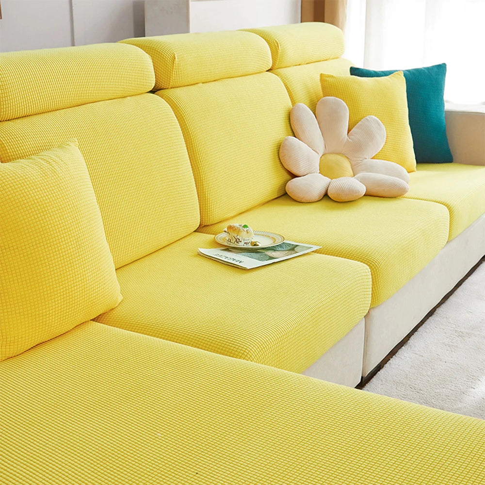 A bright yellow polar fleece jacquard sofa seat cushion cover with light beige accent pillows.