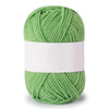 A ball of soft milk green cotton knitting yarn with a white label wrapped around the center.