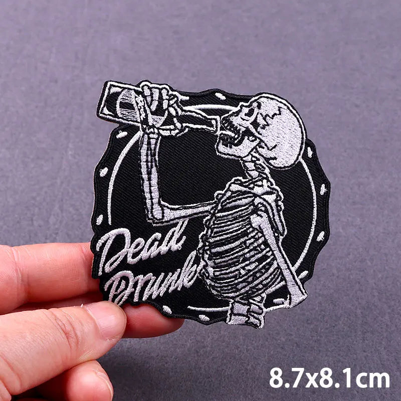 Black embroidered patch featuring a detailed skull and bone design for iron-on application