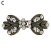 Vintage swirl clip brooch featuring gold-toned metal and clear rhinestones
