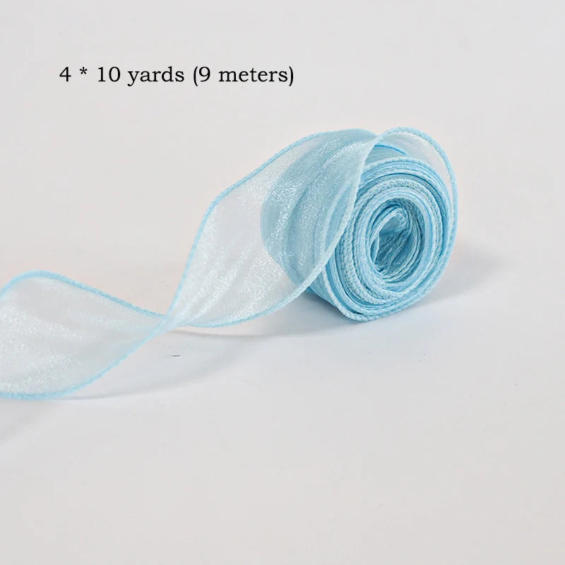 A roll of light blue silky organza ribbon measuring 4 x 10 yards.