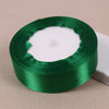 Roll of green satin ribbon used for crafting and decoration