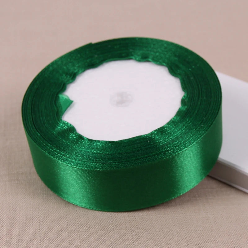 Roll of green satin ribbon used for crafting and decoration