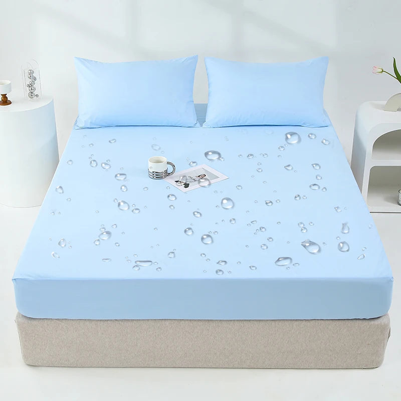 Light blue waterproof mattress and bed protector sheet with scattered water droplets on a bed.