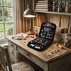 A complete multi-functional sewing kit displayed on a wooden table next to various sewing tools and fabric supplies.