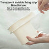 A hand is holding a transparent invisible fixing strip used to secure bed sheets.