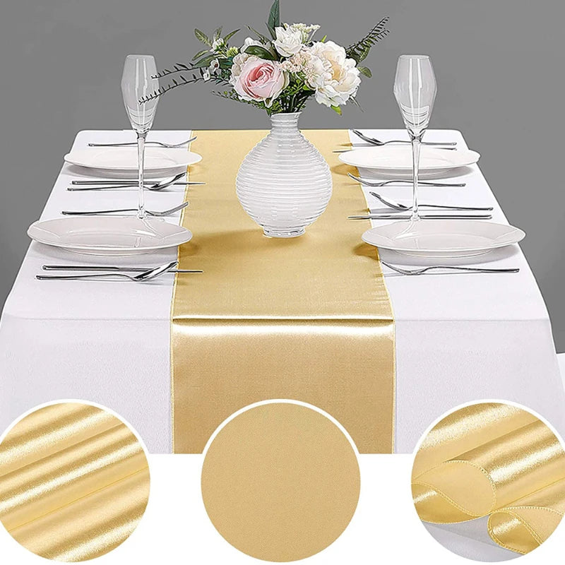 Luxury satin gold table runner set with white plates silverware and floral centerpiece