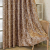 Brown tree bark pattern blackout curtains draped next to a white wooden cabinet.