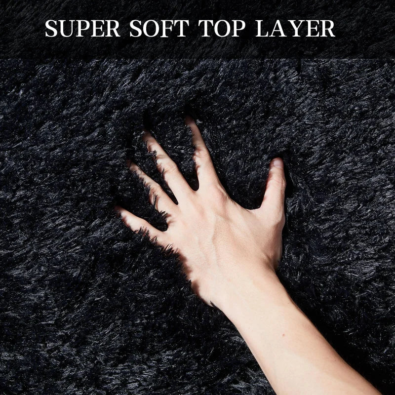 A hand is touching a dark, fluffy textile labeled Super Soft Top Layer.