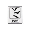 A vintage enamel lapel pin featuring a silhouette of a bird and the year 1989.