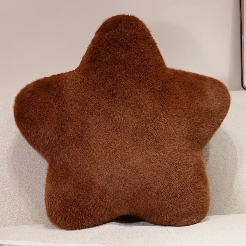A brown faux fur star-shaped decorative throw pillow.