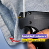 A close-up of a black sewing gun with an invisible fastener being used on a gray textile fabric.