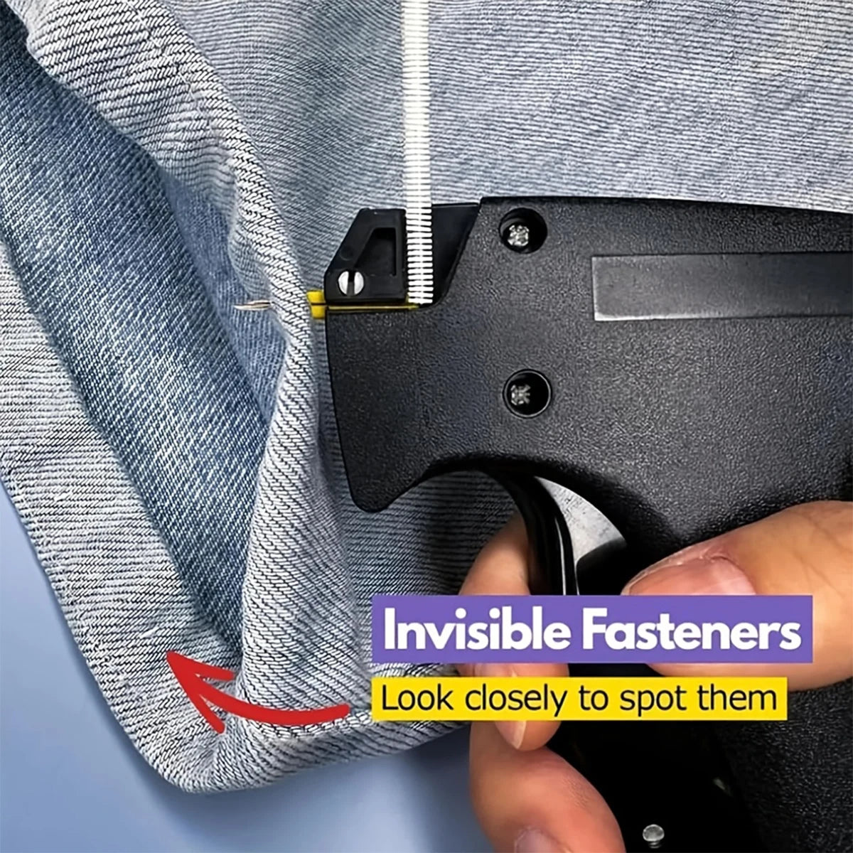 A close-up of a black sewing gun with an invisible fastener being used on a gray textile fabric.