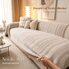 A beige woven scratch blanket draped over a sofa, designed to prevent cat scratches.