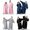 A set of oversized flannel blanket pyjama suits in pink, blue, and black for women and men.