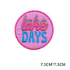 Pink embroidered patch with the text LAKE DAYS in colorful lettering