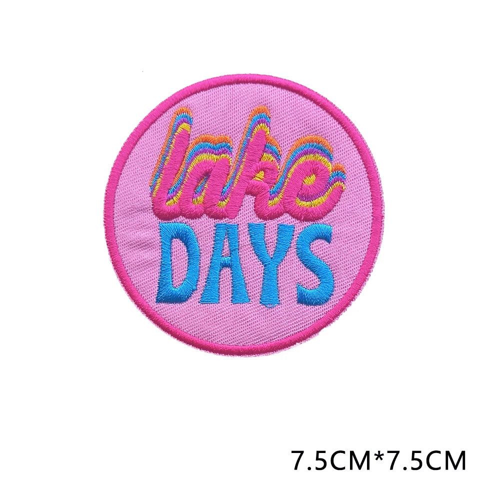 Pink embroidered patch with the text LAKE DAYS in colorful lettering
