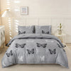 A gray duvet cover set featuring a black and white butterfly print on a bed.