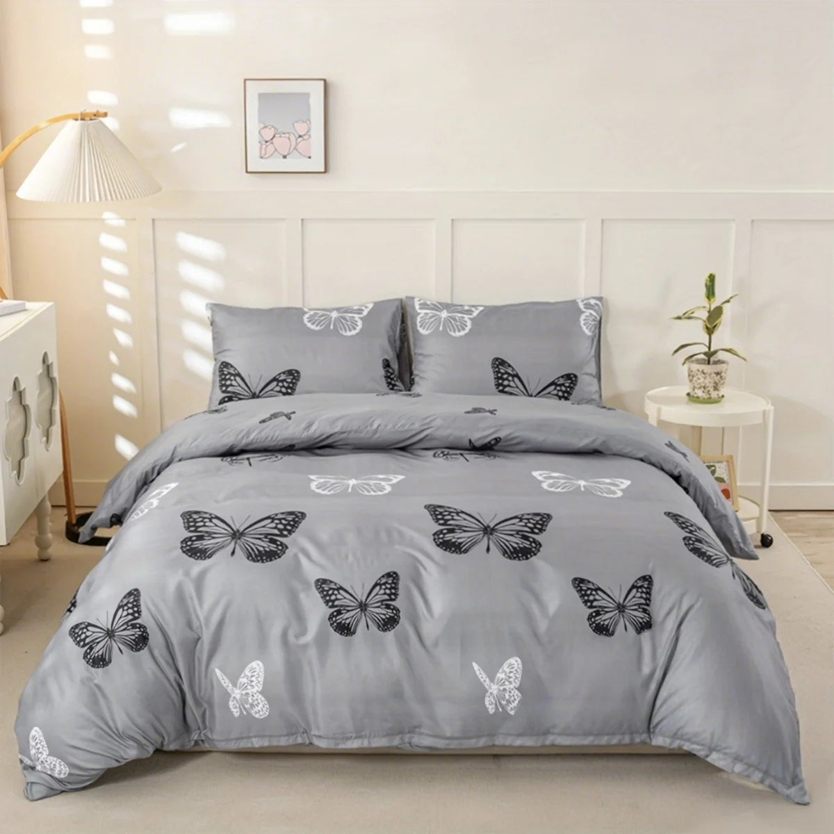 A gray duvet cover set featuring a black and white butterfly print on a bed.